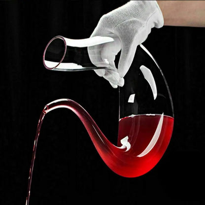 Luxe crystal wine carafe pouring red wine elegantly against a dark background.