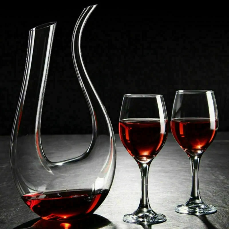Luxe crystal wine carafe with elegant U-shape design, holding 1500ml, beside two filled wine glasses.