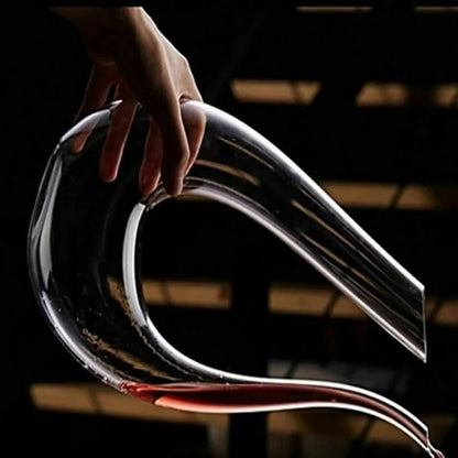 Luxe crystal wine carafe being held, showcasing its elegant U-shape design for perfect aeration and serving.